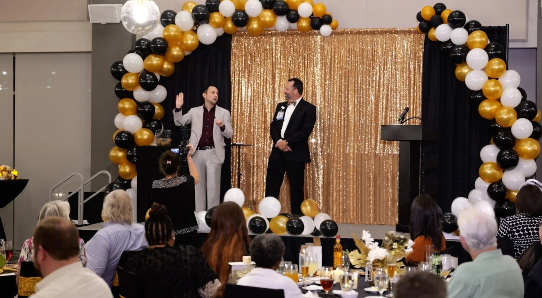Ari Novick performing close-up magic for guests during a corporate cocktail hour in Massachusetts.