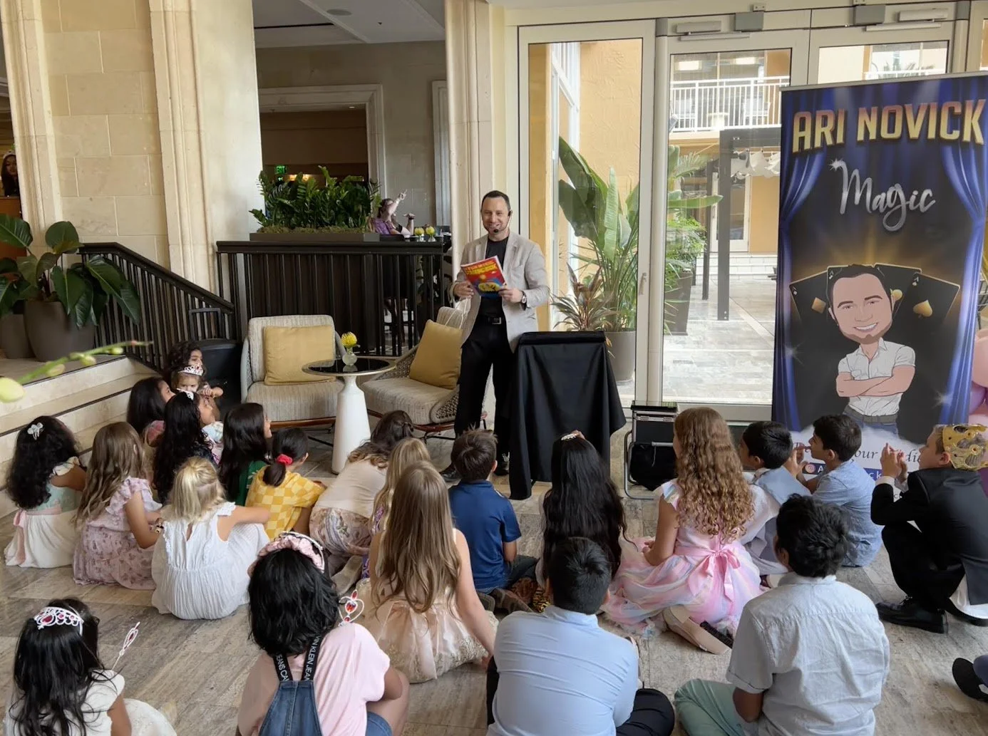 Ari Novick performing interactive magic for children at a Boca Raton event.