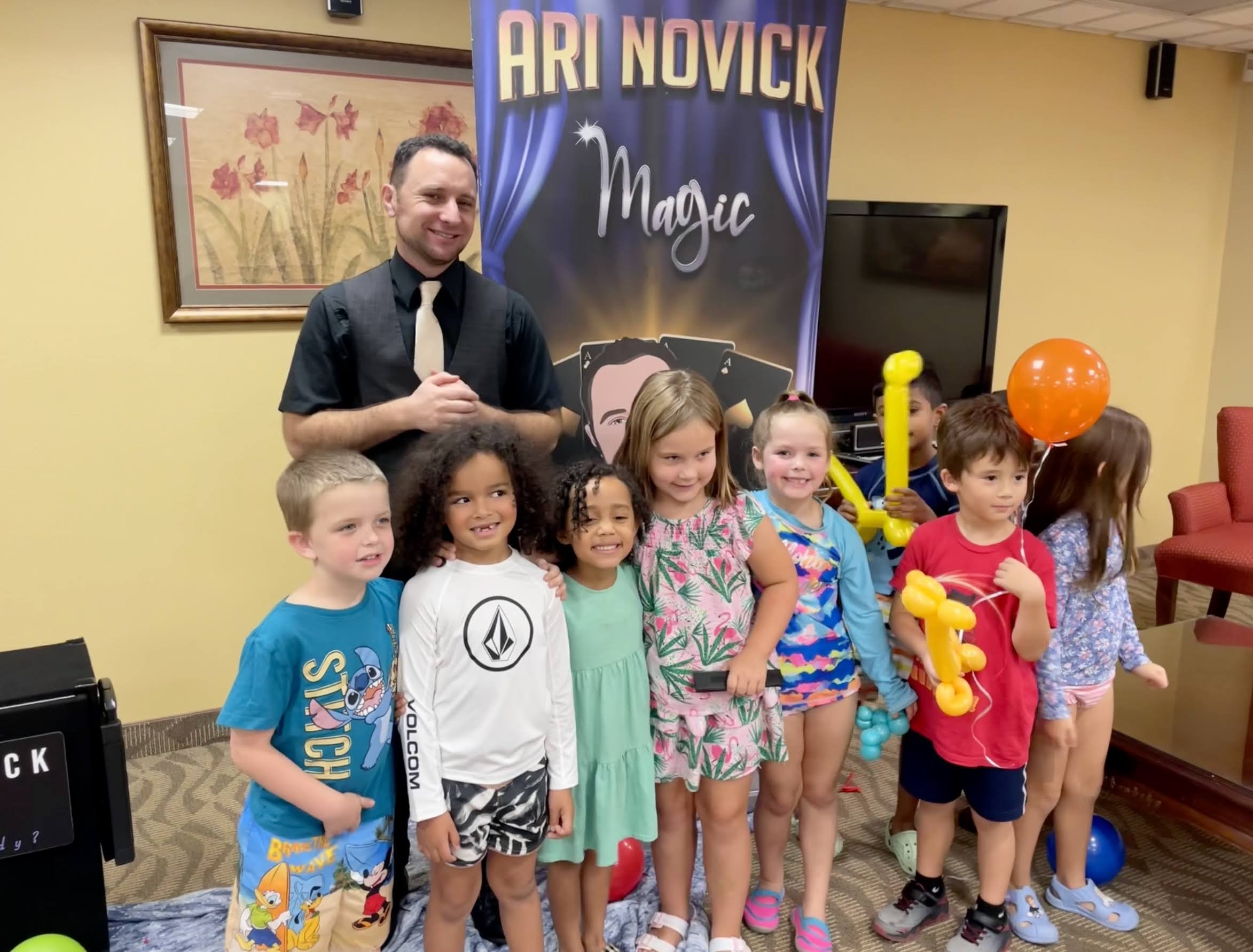 Children enjoying Ari Novick's interactive magic show at an Orlando event.