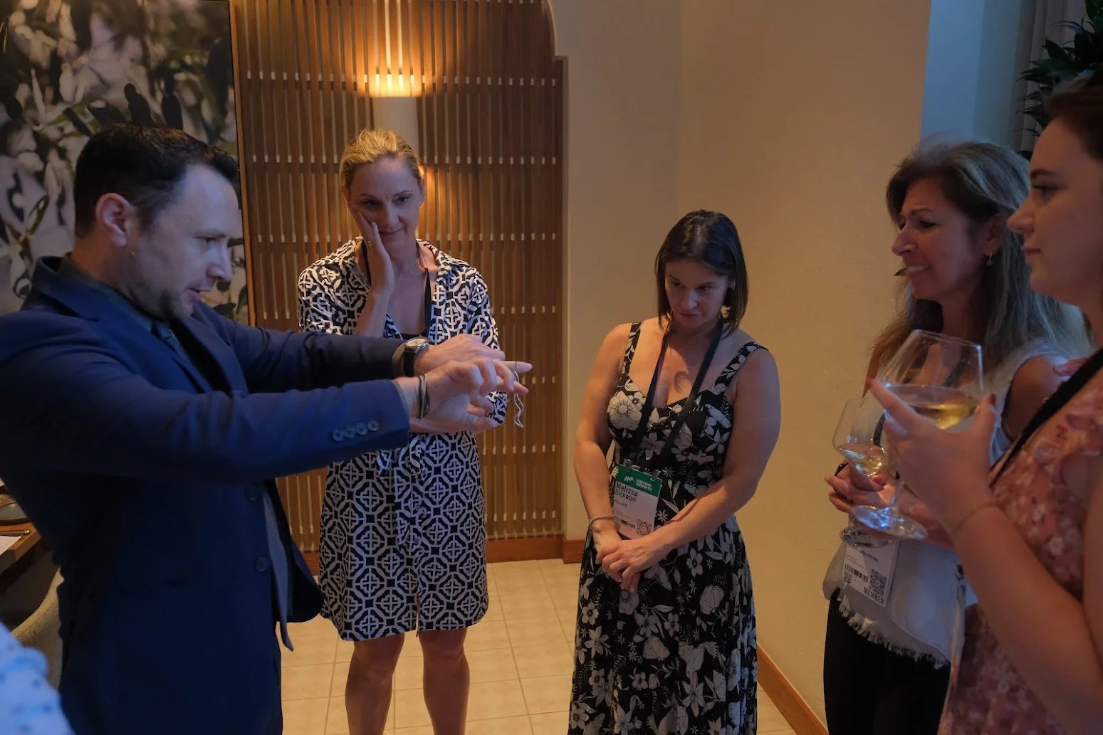 Ari Novick performing close-up magic for guests at a corporate event in Las Vegas, Nevada.