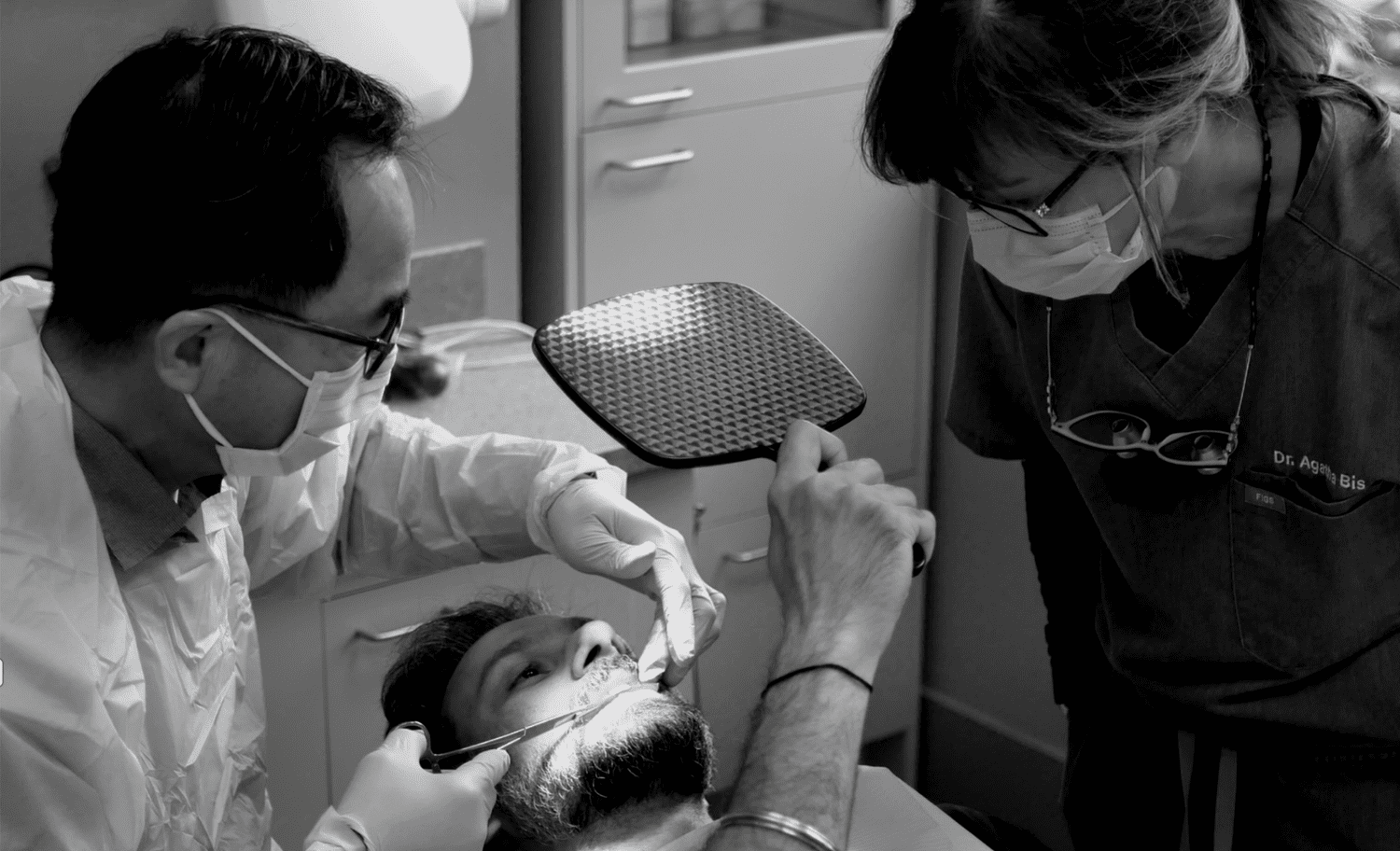 Dr. Agatha Bis teaching a dentist chairside during a hands-on course.