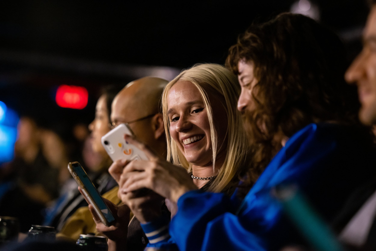 Audience members texting during The Life Robotic