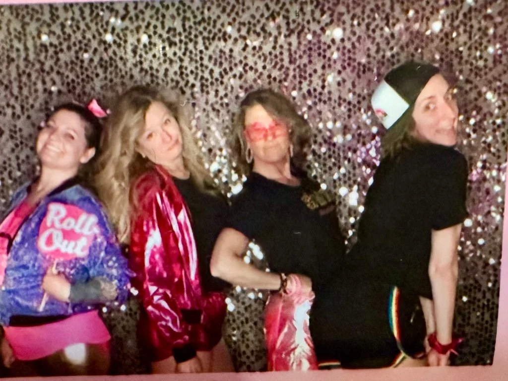 Friends in colorful outfits posing together at Shinecation 2024