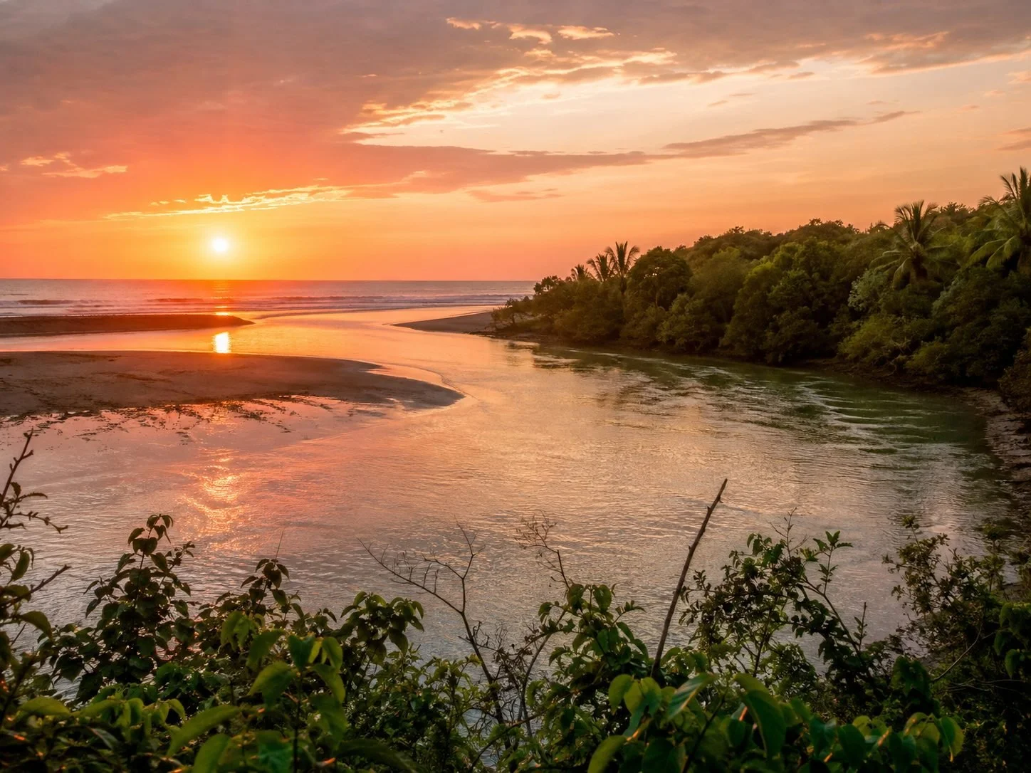 aerial of the river mouth at sunset