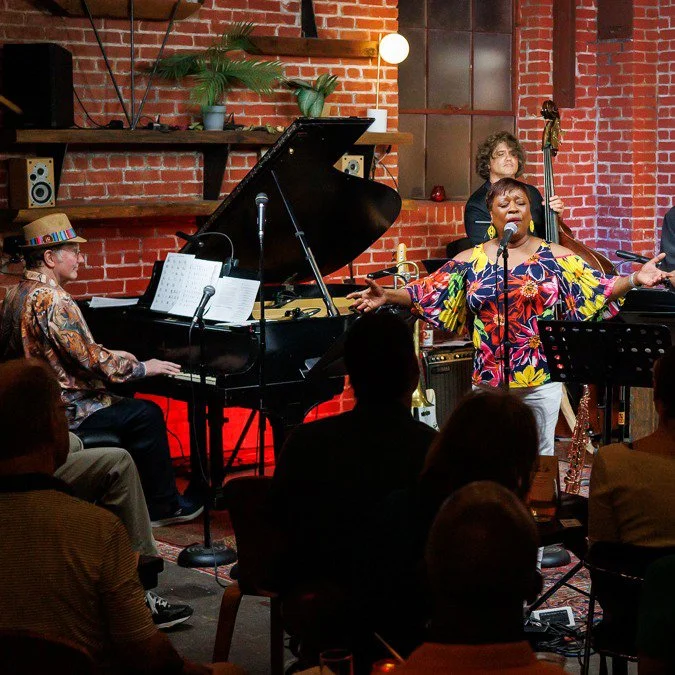 Pam Hart singing with Hank Hehmsoth at the piano during a live jazz performance