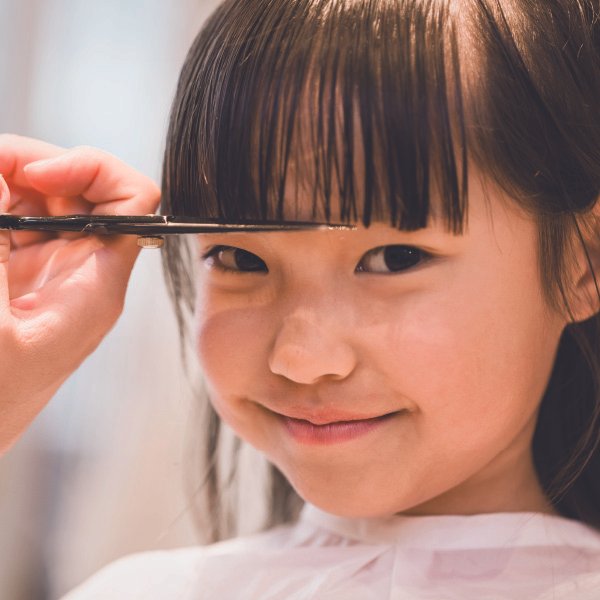 Little girl getting a haircut.