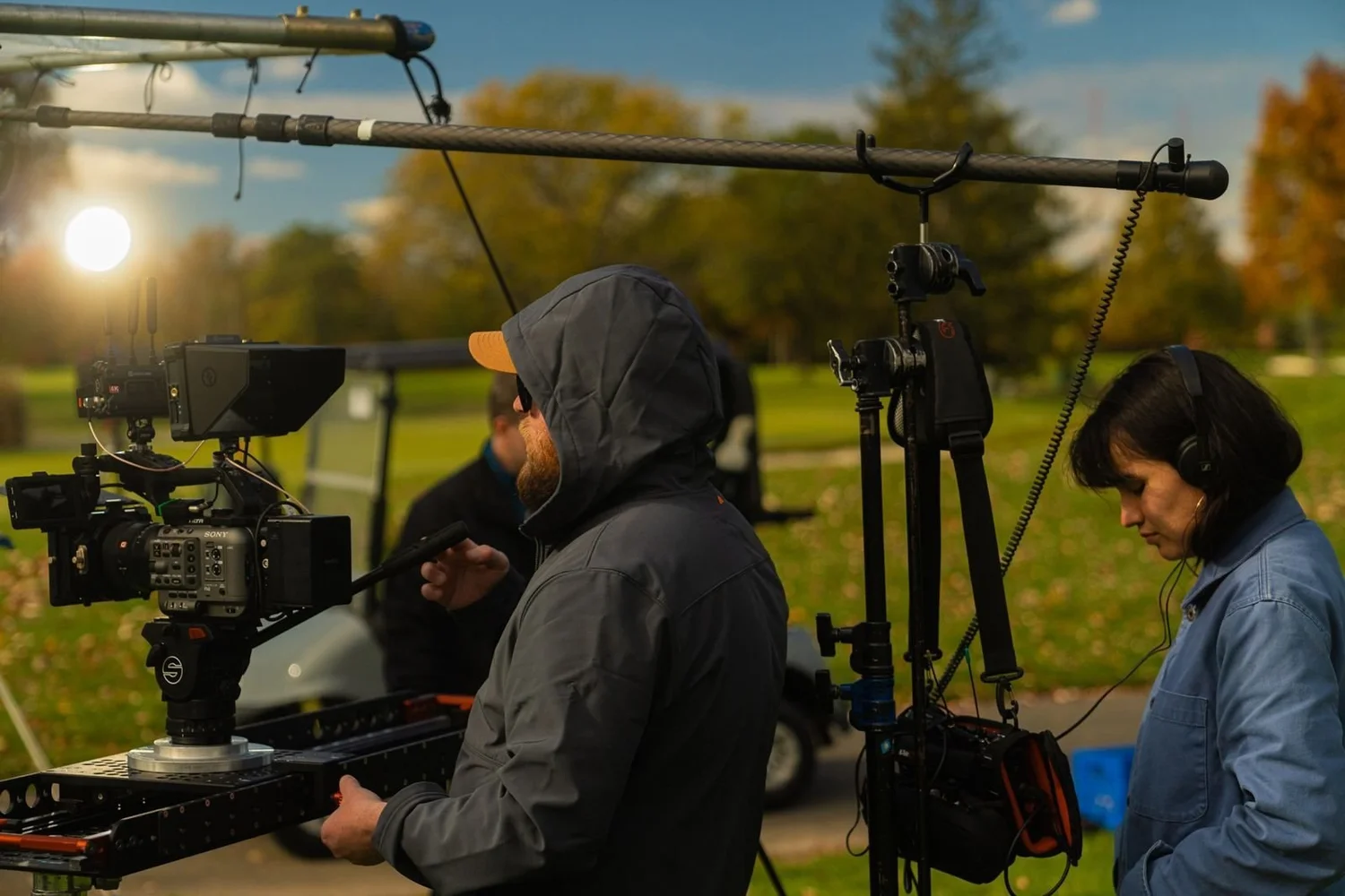 Loud Media crew with a slider and boom in autumn light