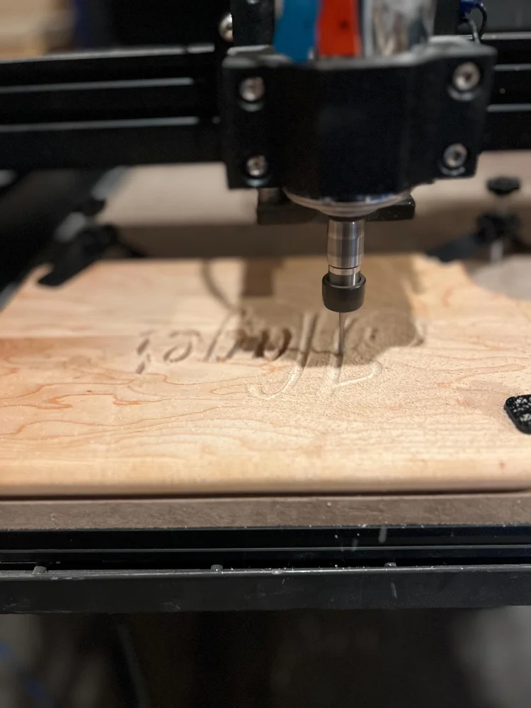 A cutting board being engraved on the CNC machine
