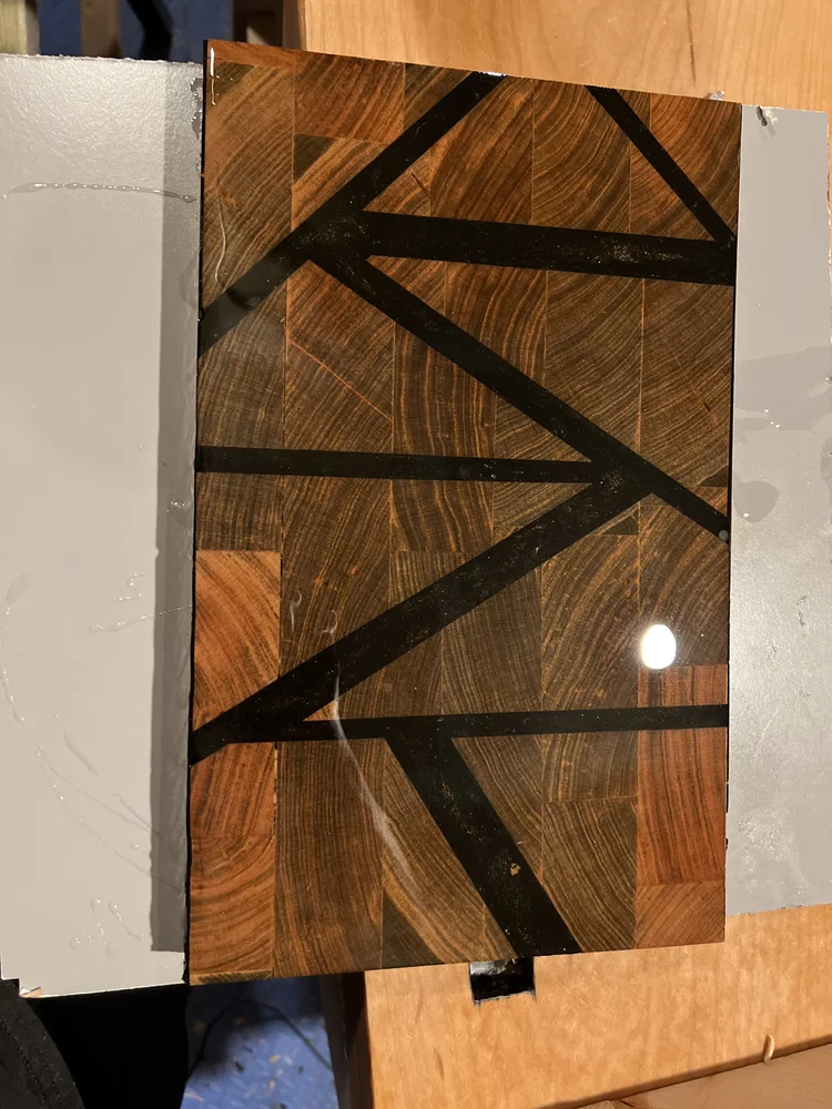 A wood inlay panel with dark geometric lines