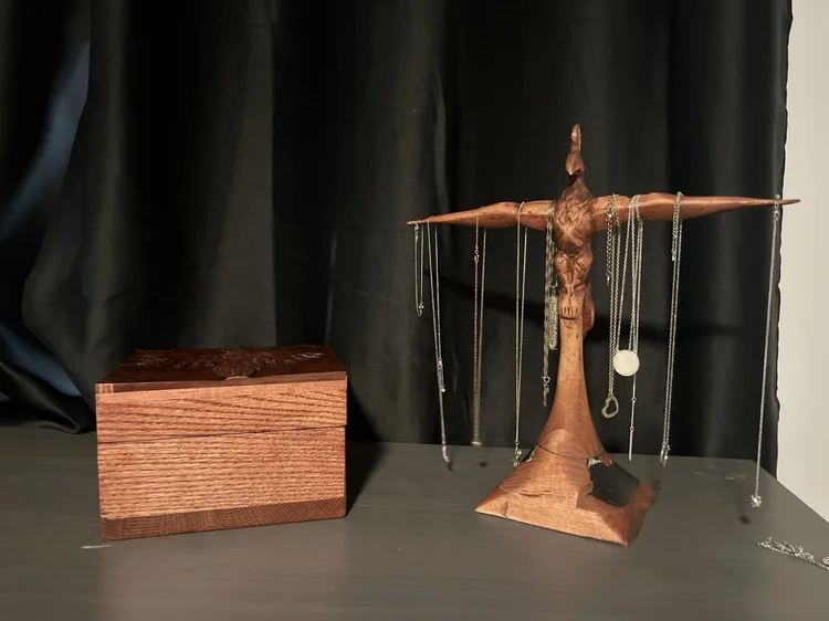 A wooden jewelry stand