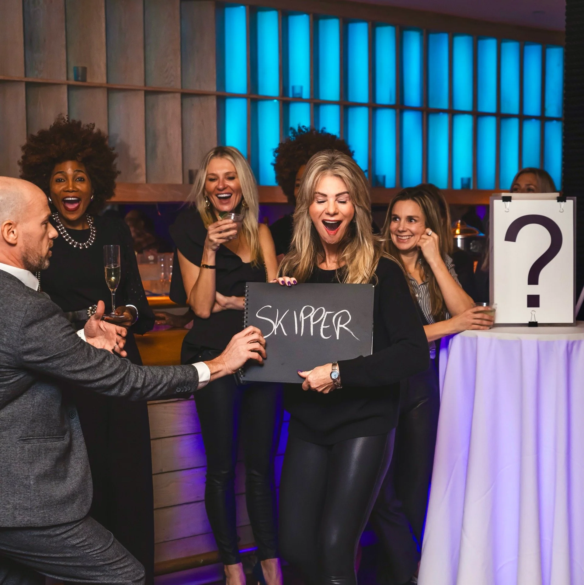 Guests react as Fred Berthelot reveals a thought at the Jimmy Jimmy Foundation fundraiser