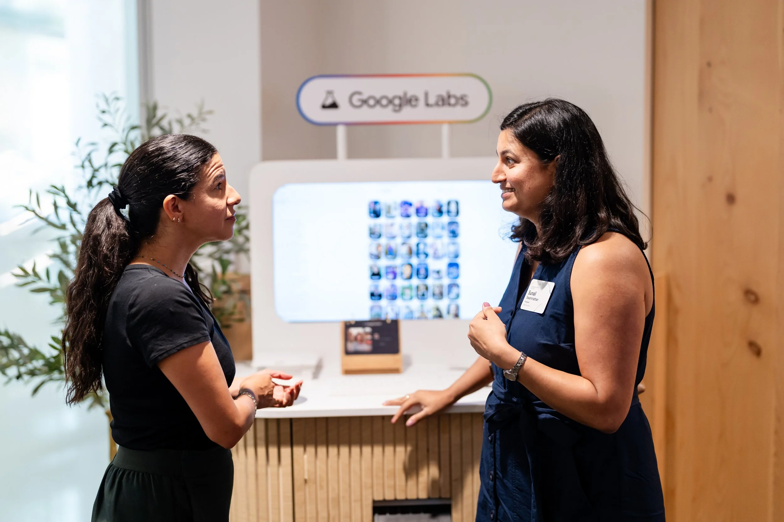 Attendees discussing a Google Labs demonstration