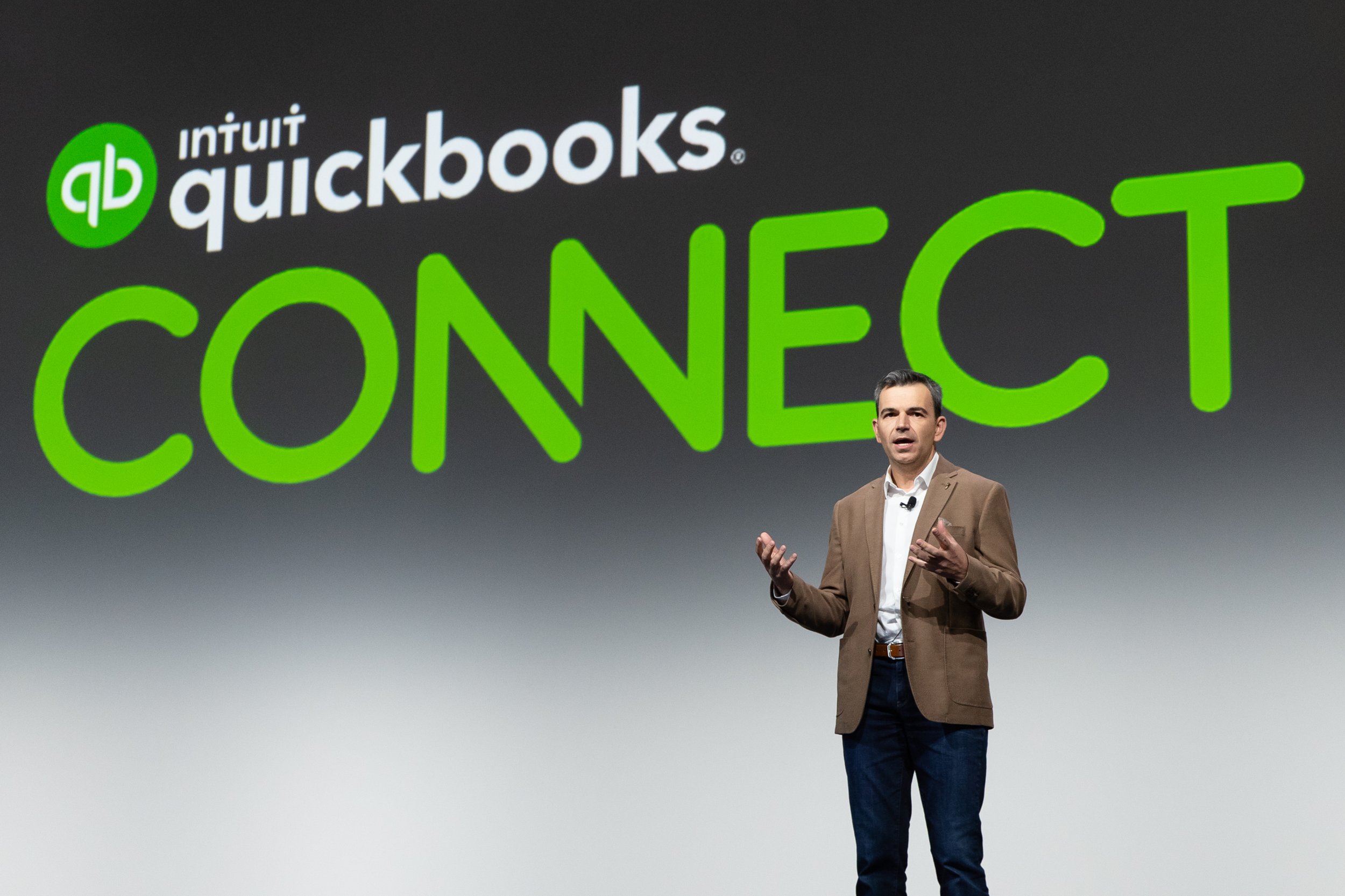Presenter discussing financial solutions at QuickBooks Connect, providing insights into better business management.