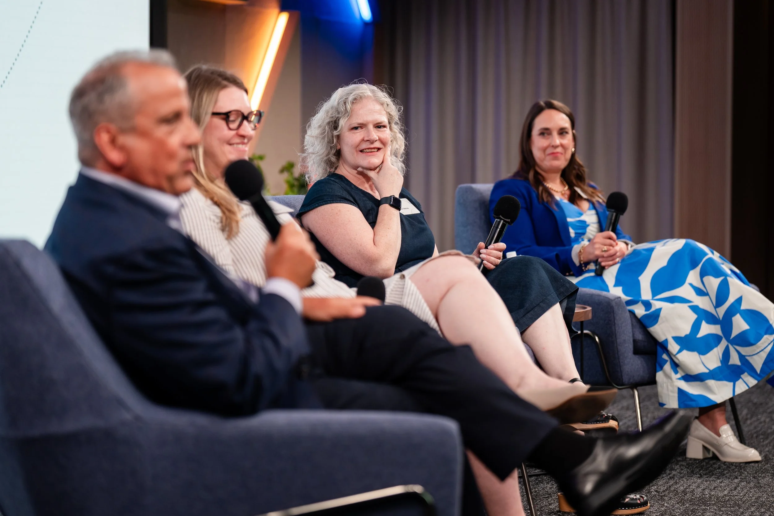 Four speakers participating in a panel discussion