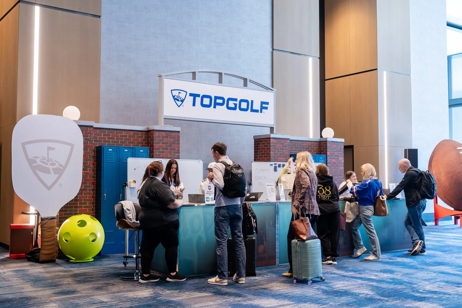 Welcome desk at Topgolf Maker 2026, photographed by Uptown Media