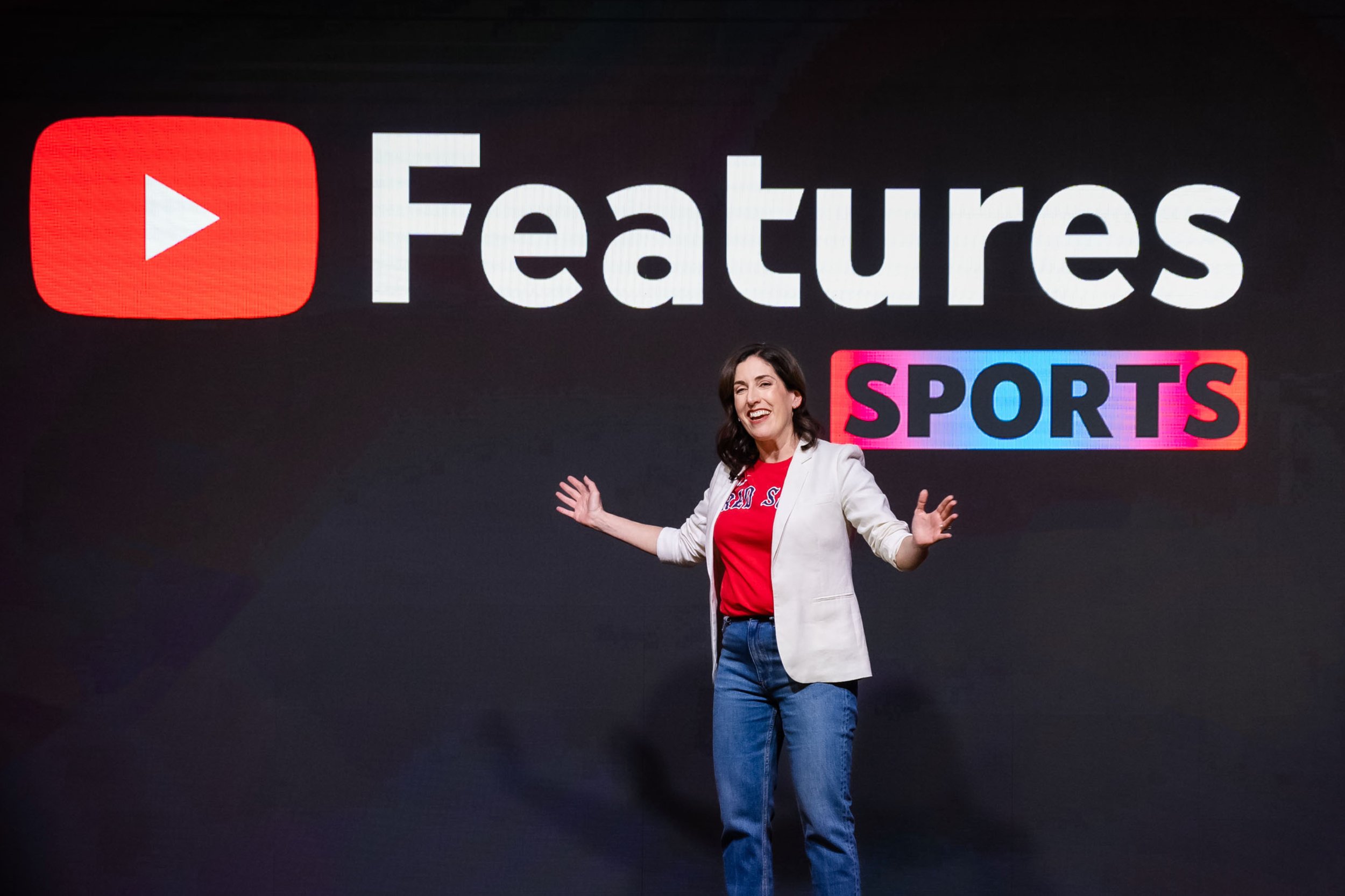 Female presenter discussing sports innovations at the Features Sports event, captured by Uptown Media.