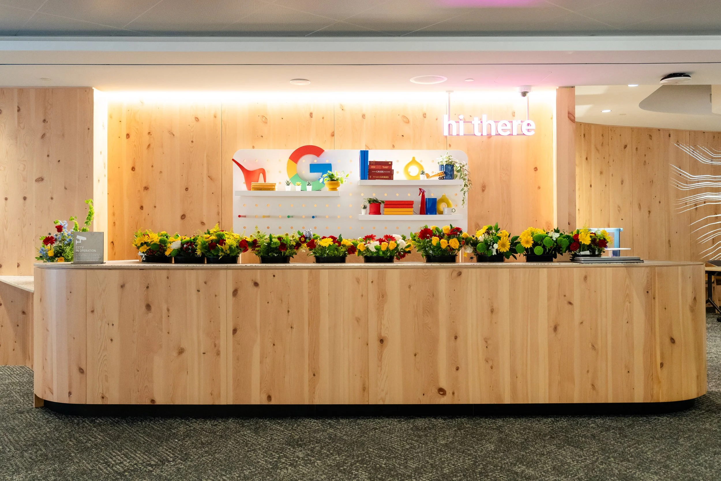 Google event registration desk with branded details and florals