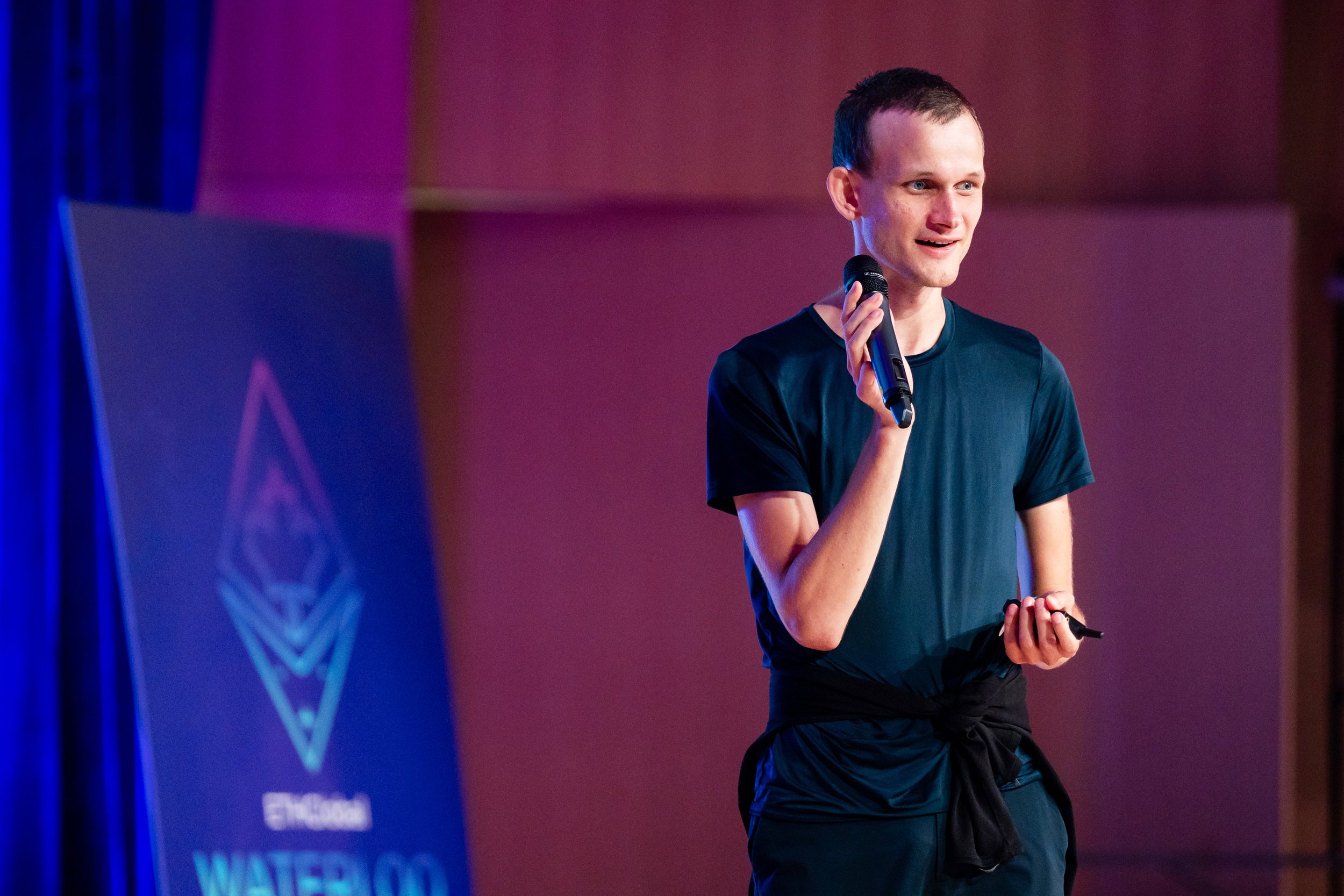 Vitalik Buterin, founder of Ethereum, speaking at a tech conference, addressing developments in blockchain technology.