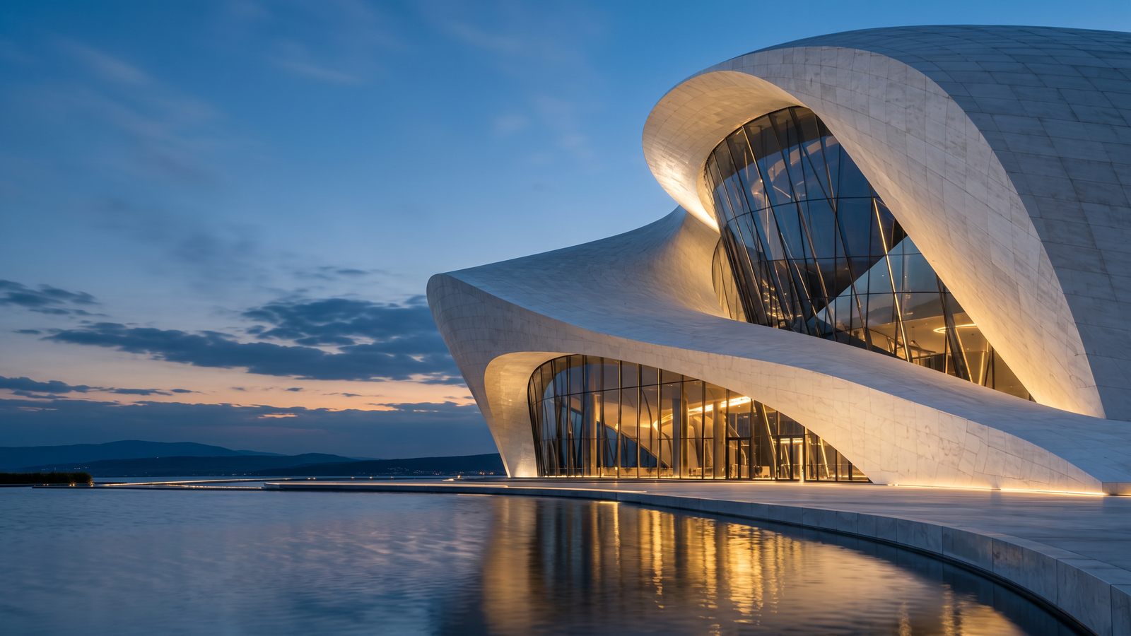 Sculptural modern architecture in stone and glass at blue hour