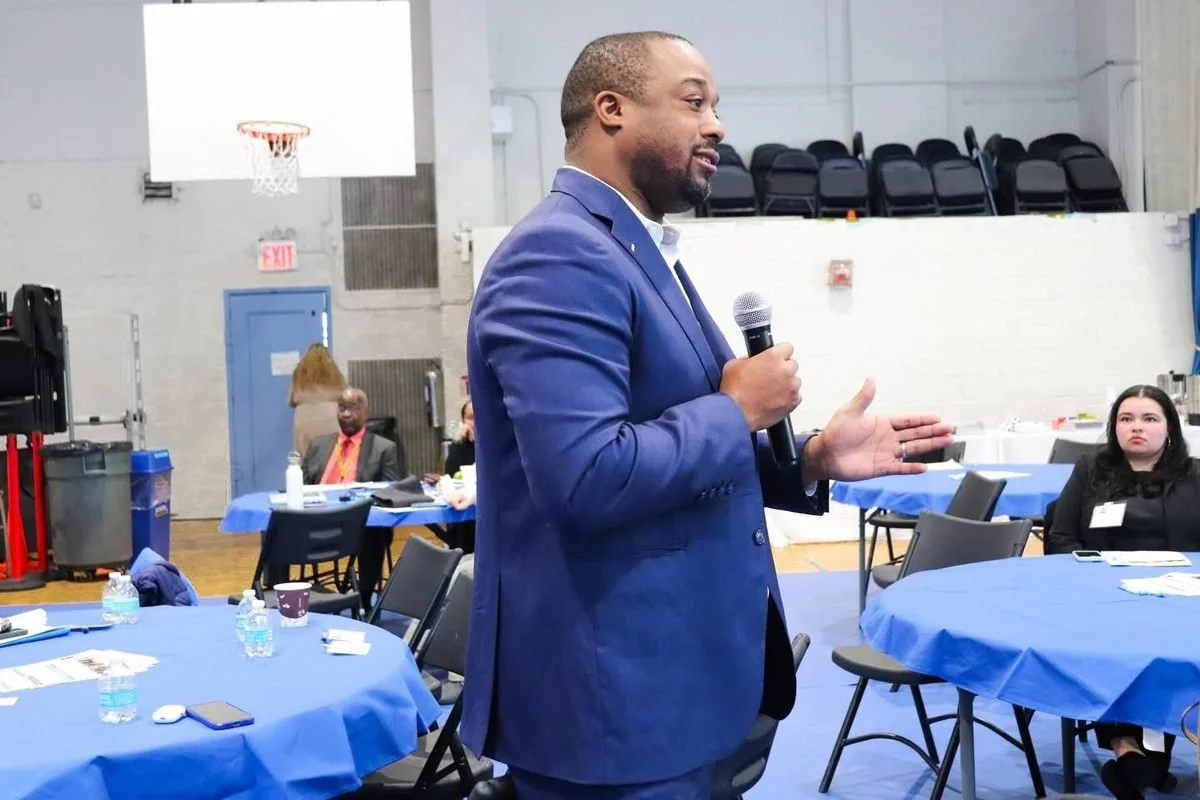 Landon Dais speaks with residents at a BronxWorks community event