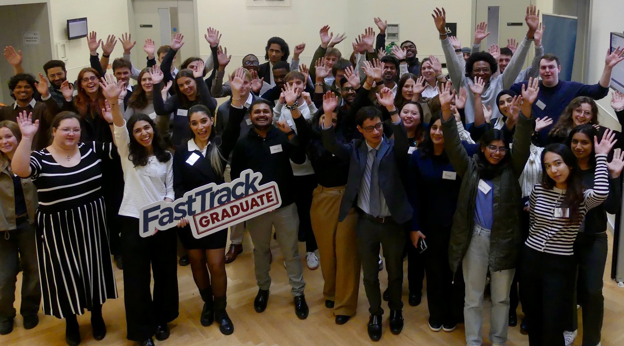 A Graduate FastTrack cohort waving at the camera