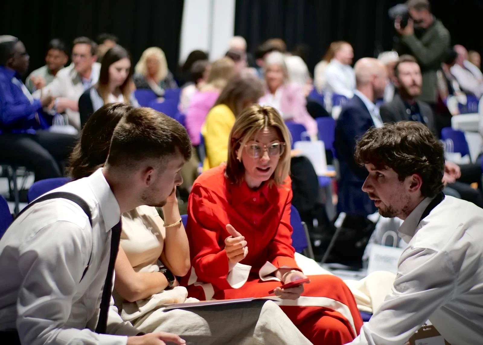 An industry professional in conversation with graduates