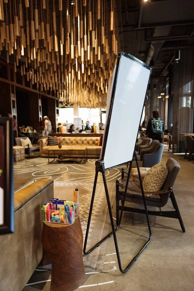 An empty Seattle meeting room set up for a Henley leadership retreat, with a flip chart and supplies ready for the day