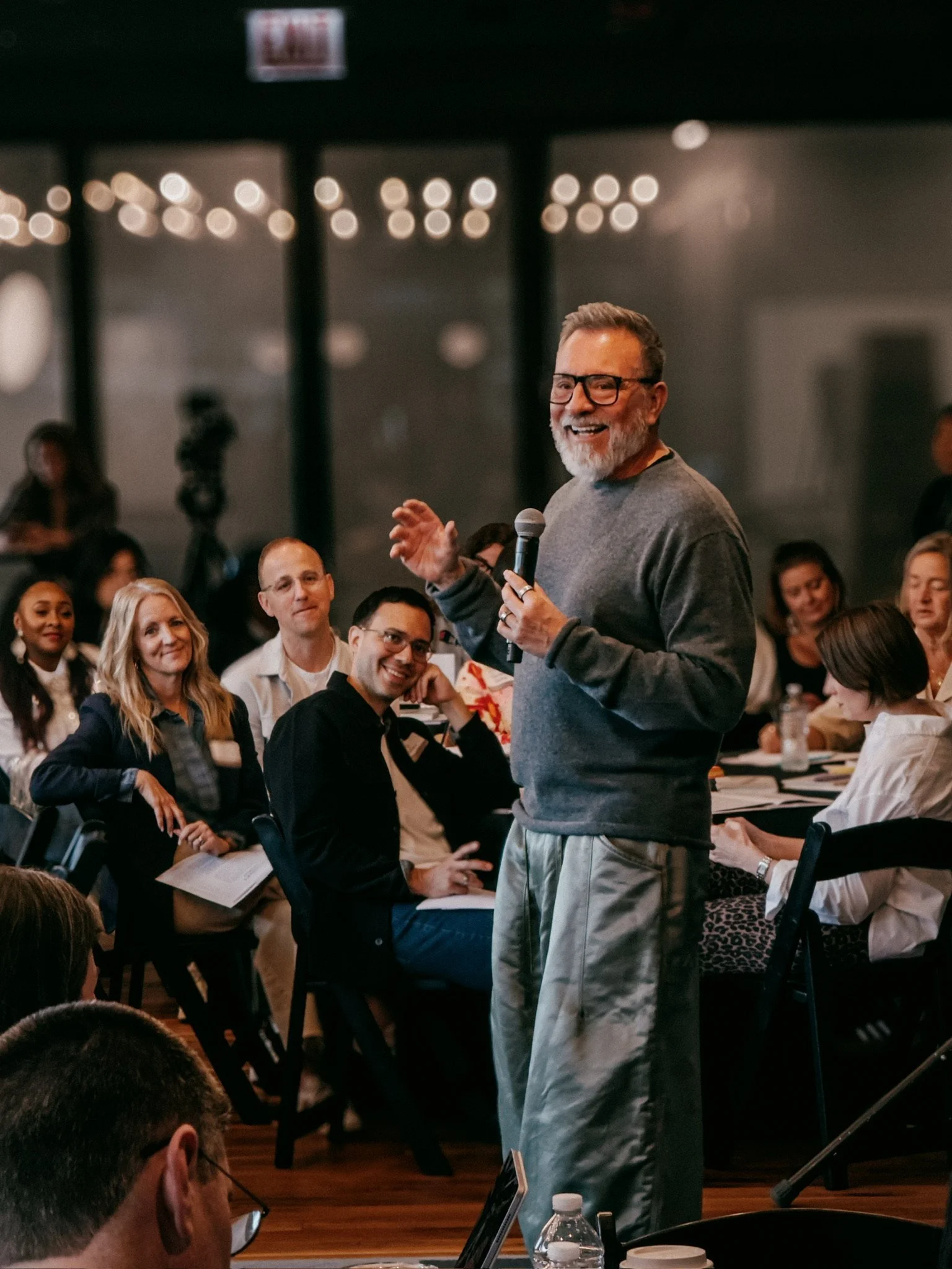 Erwin Raphael McManus laughing among seated members at a live gathering