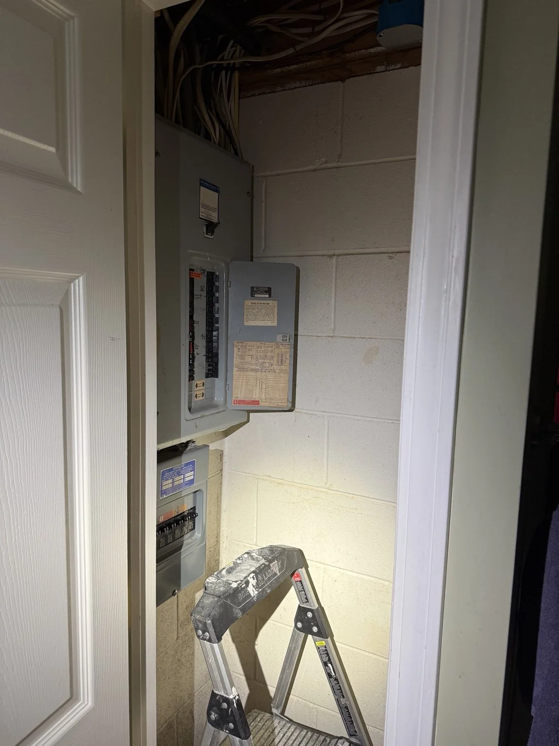 Original electrical panels inside Sandra’s bathroom closet before relocation by JJM Electric