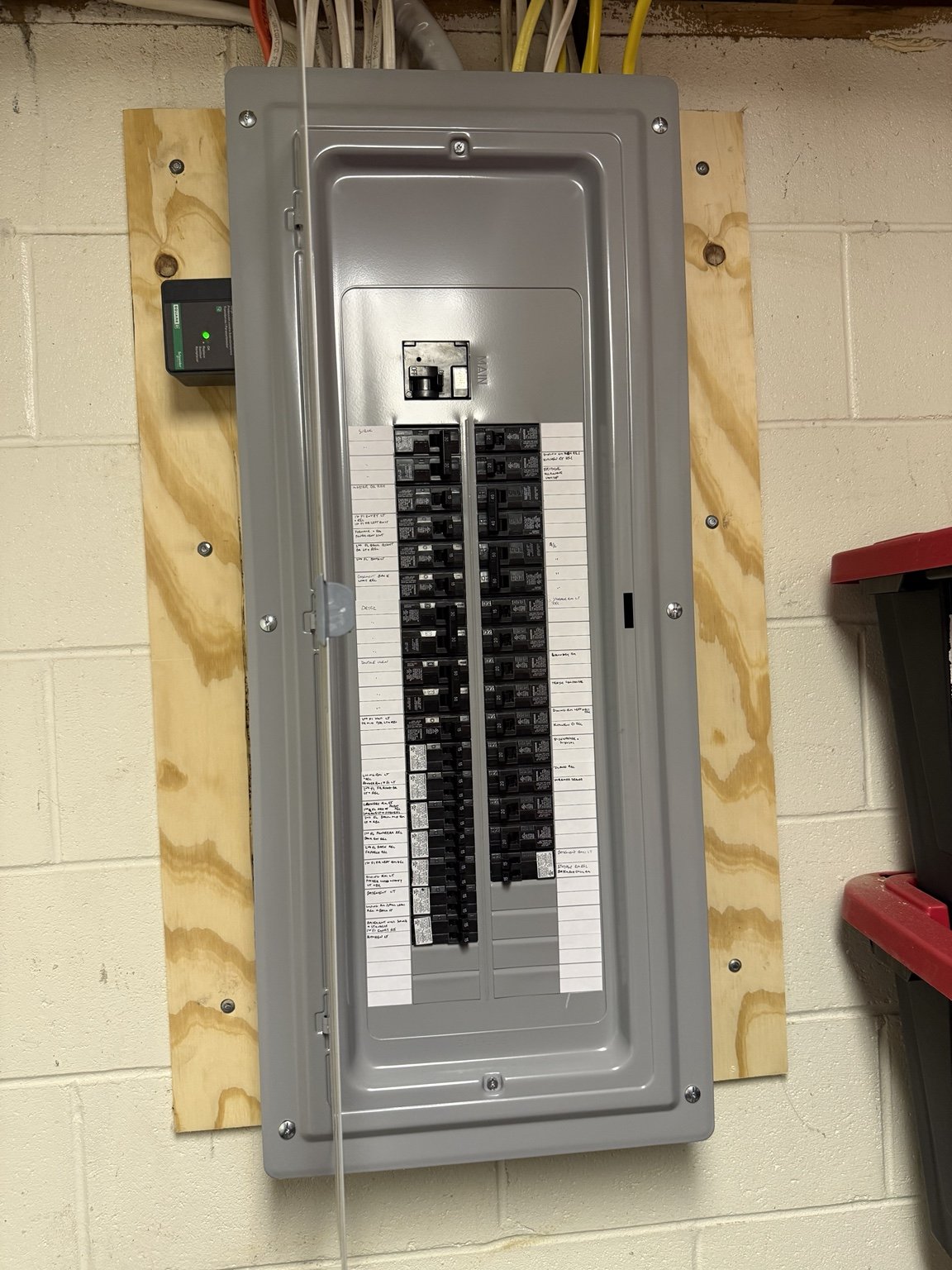 New 200-amp Siemens main-breaker panel in the adjacent room with Square D whole-home surge protection