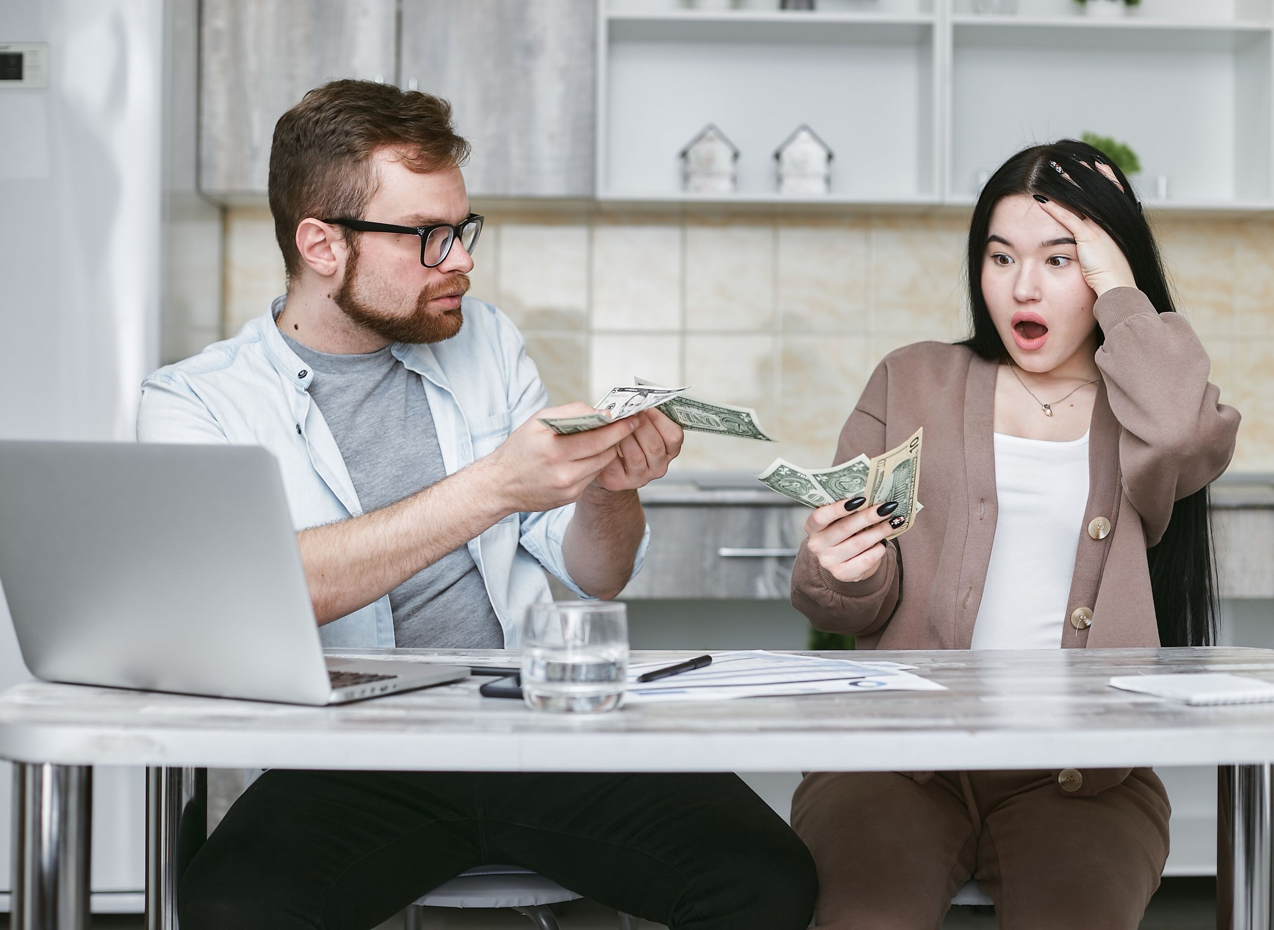 Couple sitting together at home discussing finances