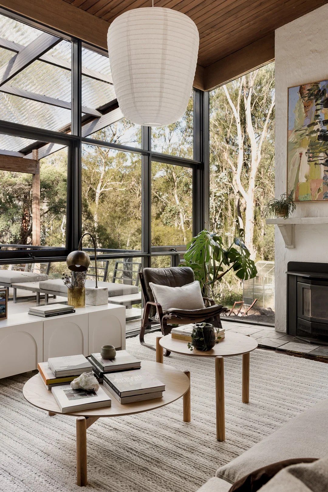 Living room seating beside floor-to-ceiling glass