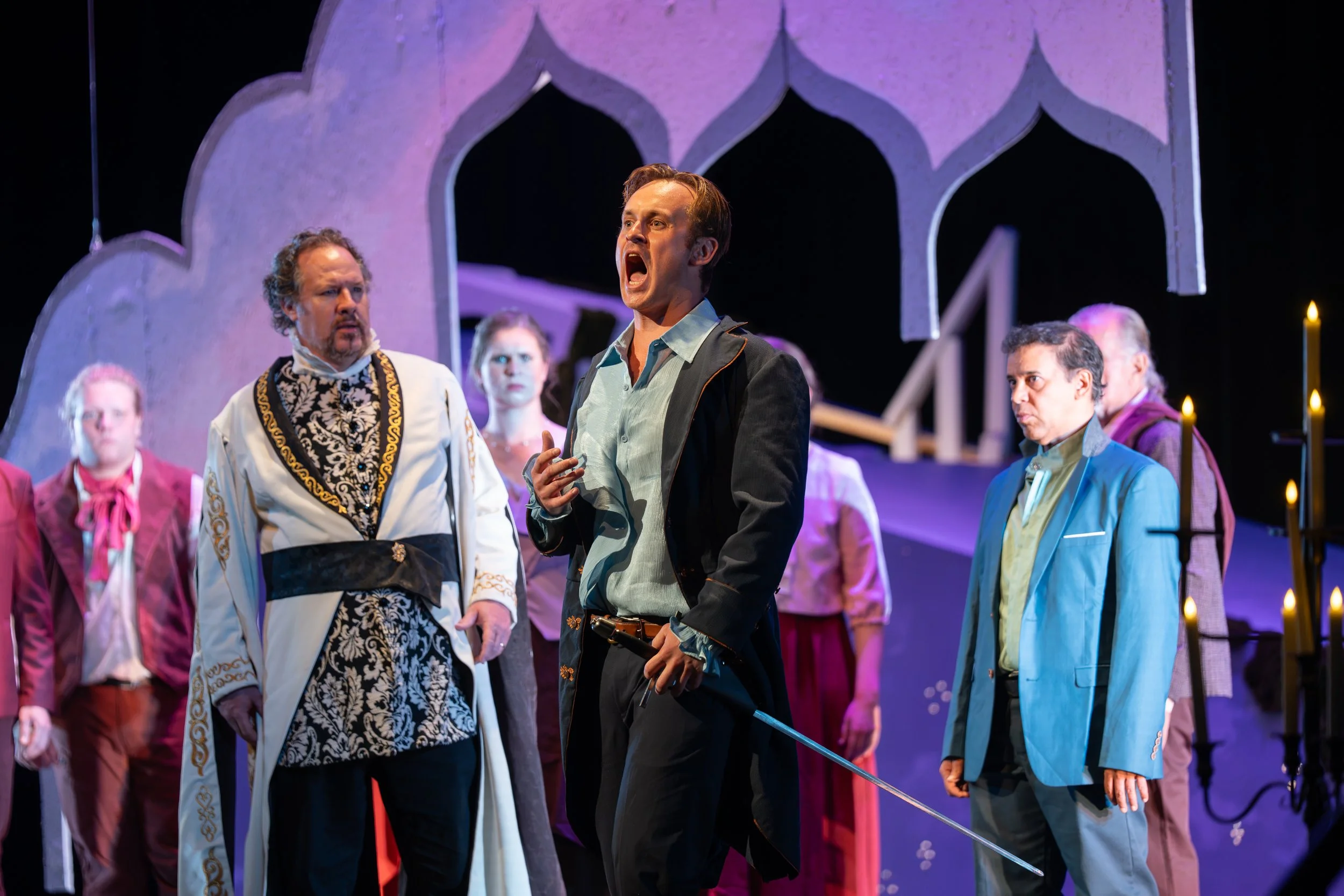 Patrick Bessenbacher as Roméo sings amid the full cast on the Eccles Center stage