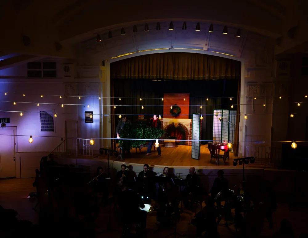 The Gift of the Magi on the Clubhouse SLC stage under strings of lights, December 2025