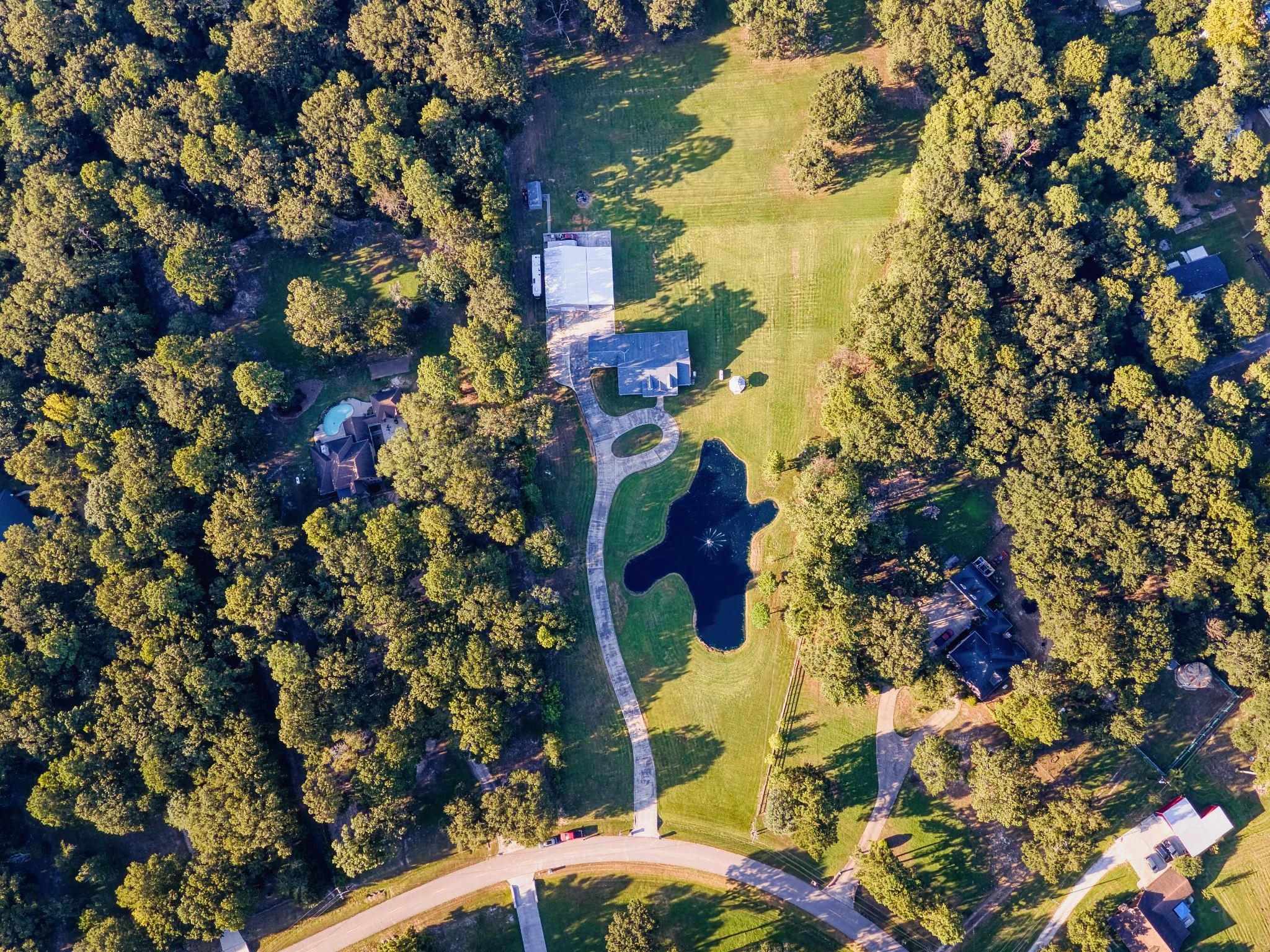 Aerial photograph of a wooded residential property