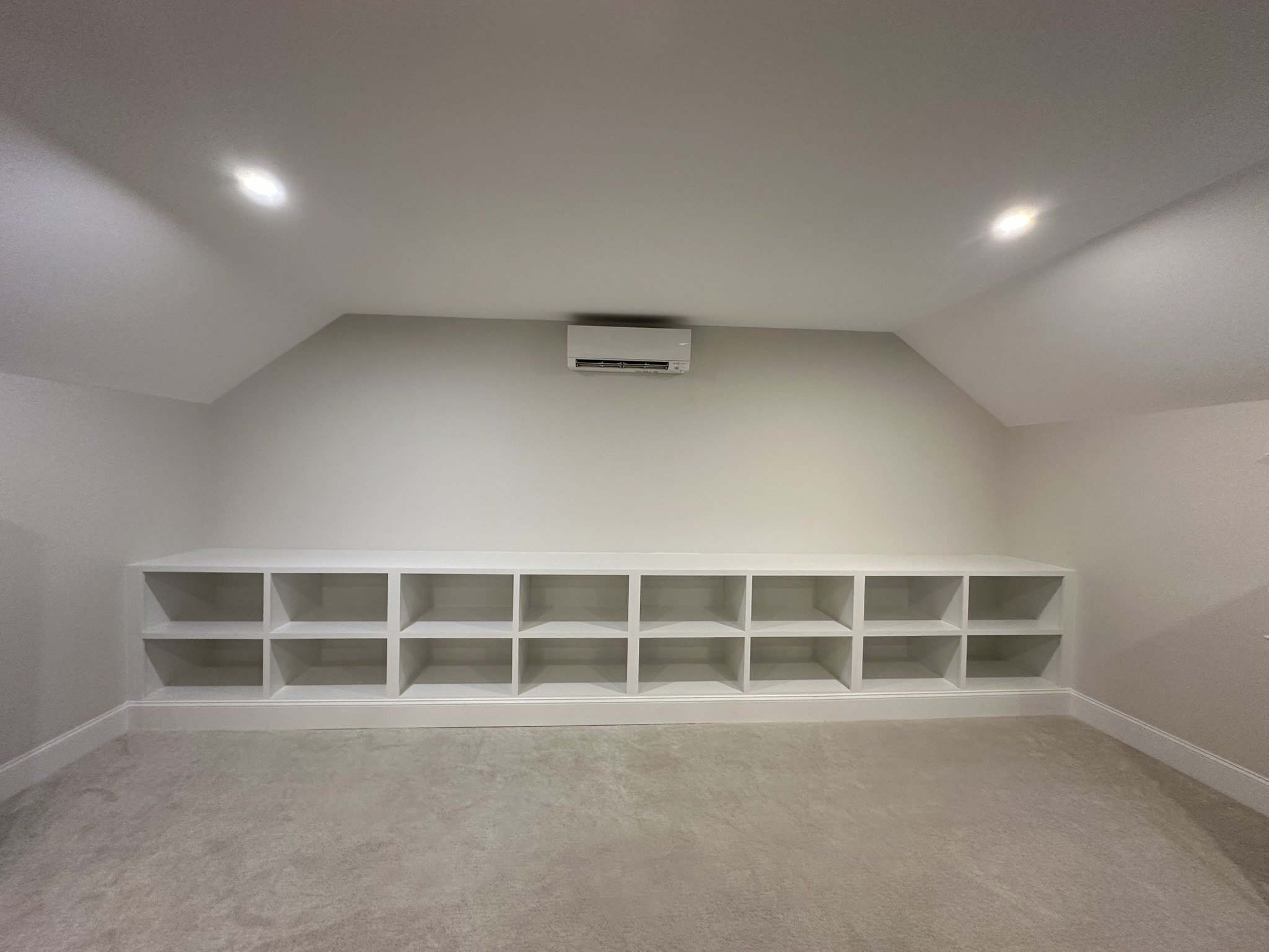 Storage cubbies fitted into an attic knee wall