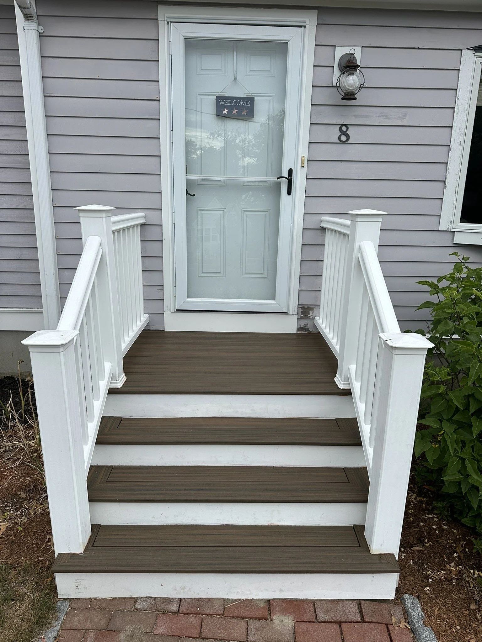 Composite entry steps with white railing