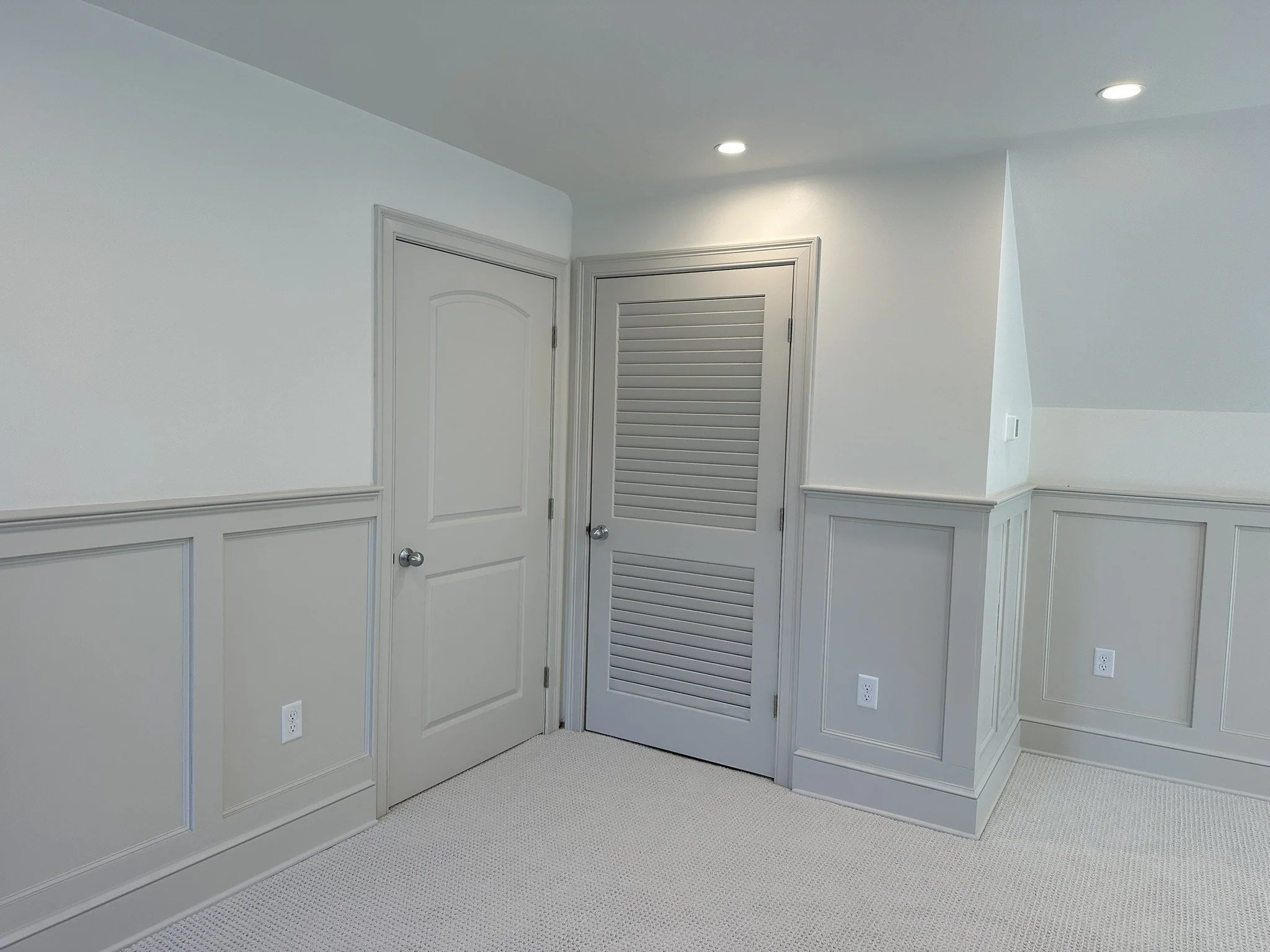 Paneled attic knee wall and louvered access door