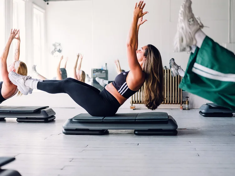 A member holding a V-sit on the step bench