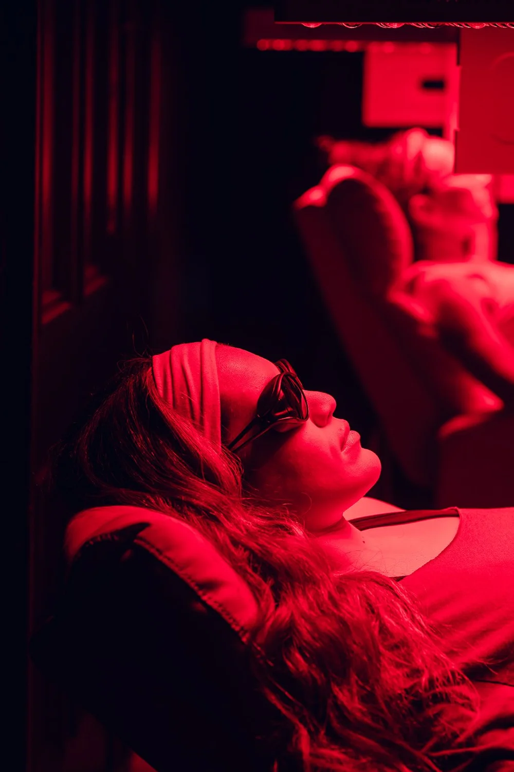 A member relaxing under the red light panels in our recovery room
