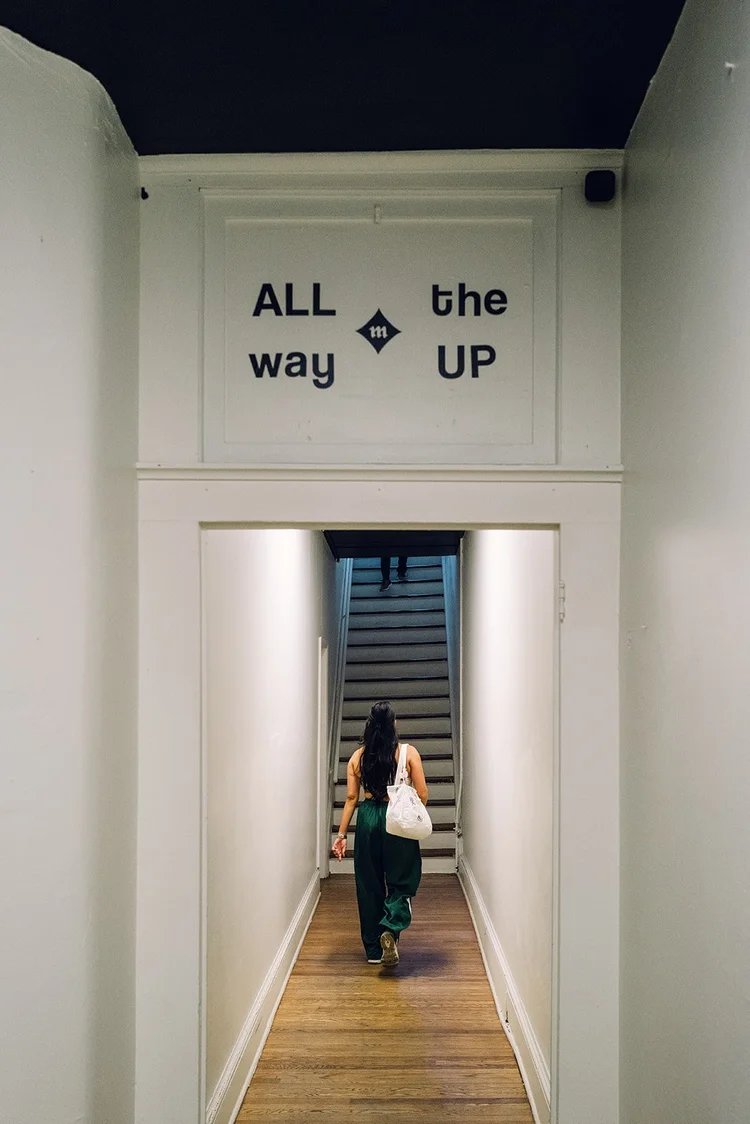 The hallway sign reading All the way up