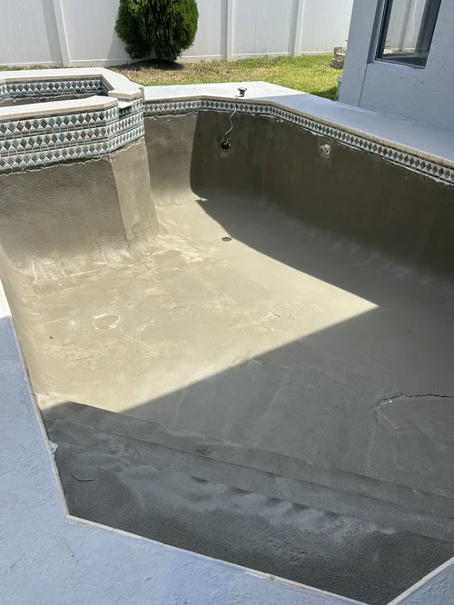 Drained swimming pool and raised spa during surface preparation in The Heights, Jupiter.