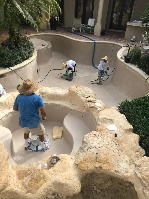 Crew resurfacing a residential pool and spa in BallenIsles.
