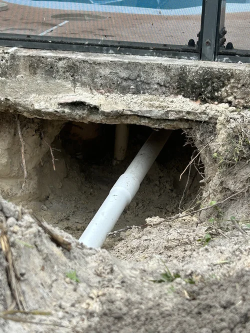 Exposed skimmer plumbing during a pool leak repair in Jupiter Farms.