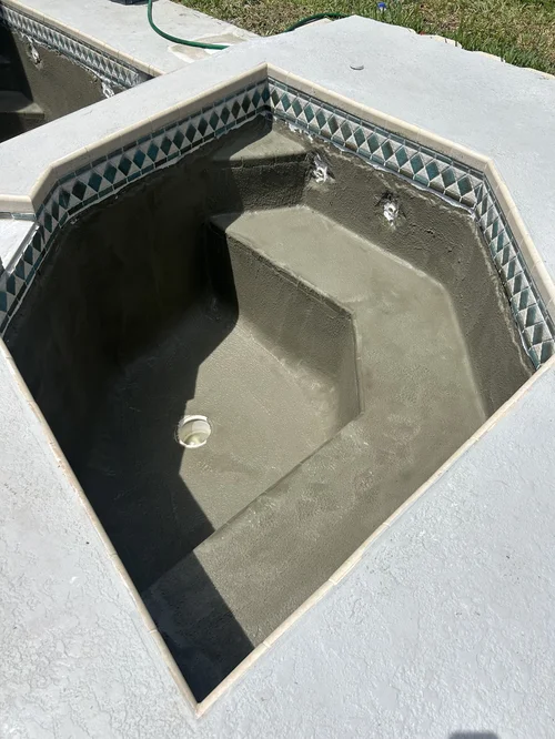 Raised spa with its surface being prepared during a Jupiter resurfacing project.