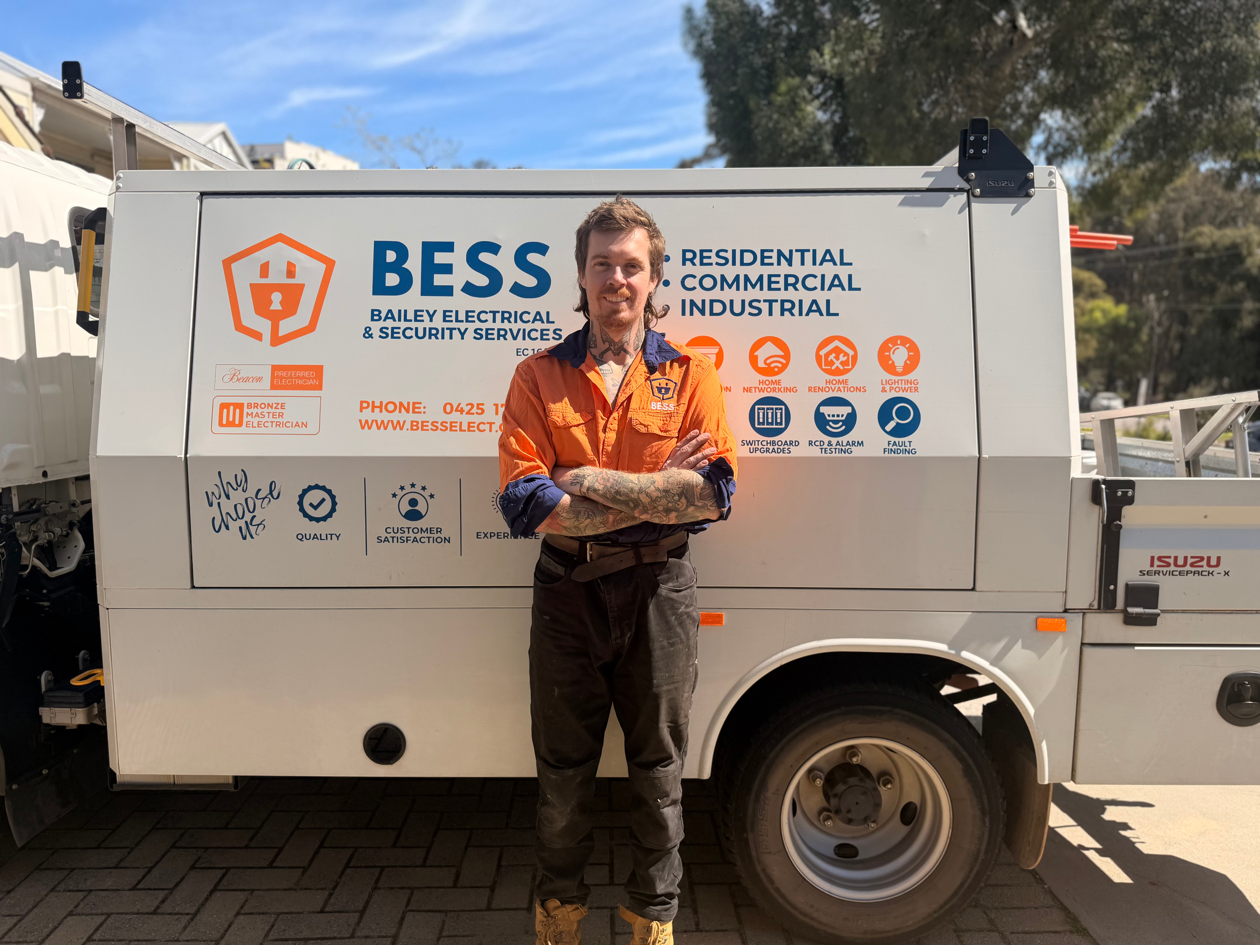 BESS electrician with Bailey Electrical and Security Services vehicle in Perth