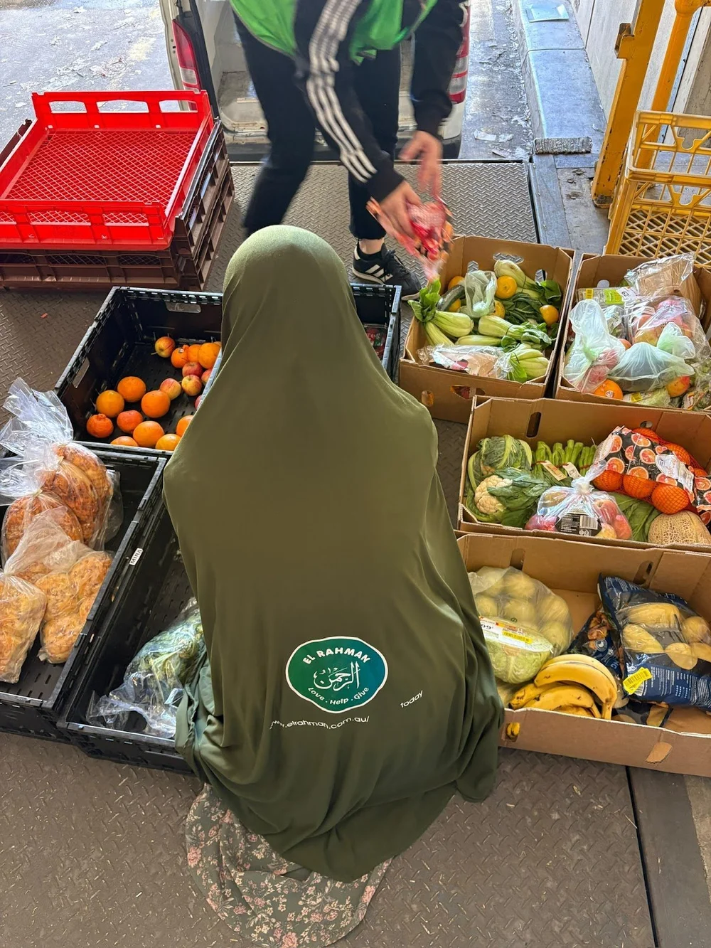 El Rahman volunteer sorting crates of fresh produce