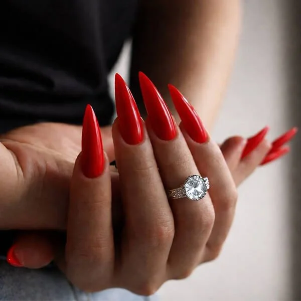 Long glossy red stiletto gel nail extensions at Nail House USA in Jacksonville