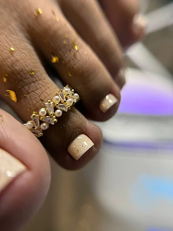 Russian dry pedicure with creamy white gel polish and gold foil details
