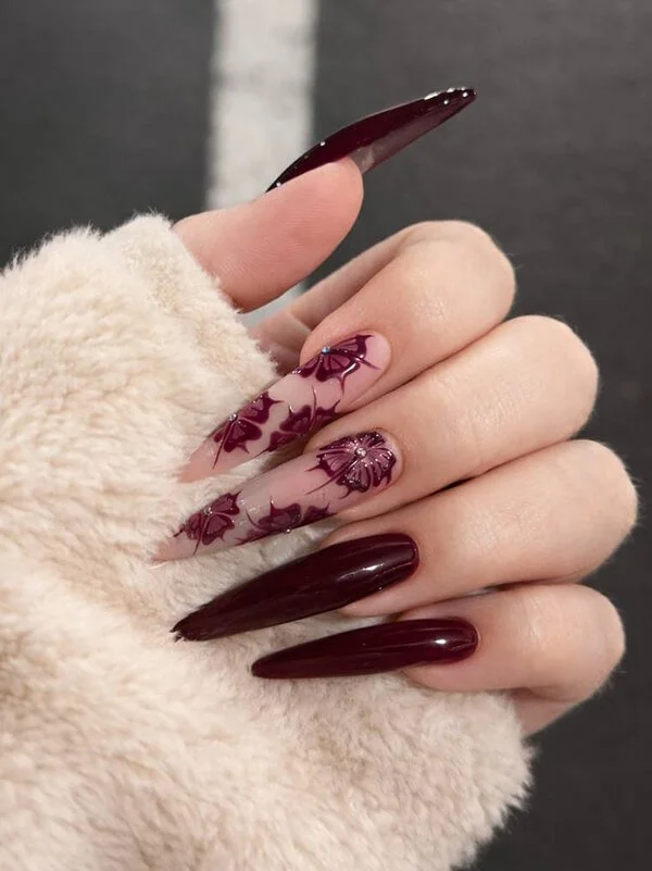 Burgundy stiletto gel nail extensions with floral nail art at Nail House USA in Jacksonville